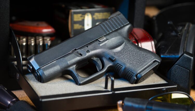 A photo of a pistol in a gun safe.