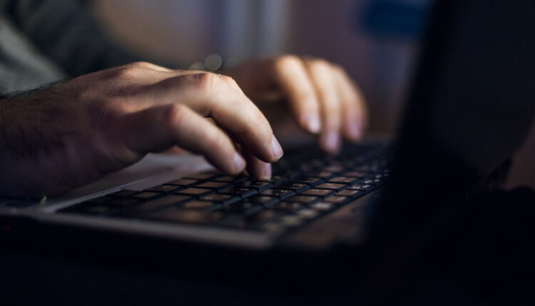 A close-up of shot of an hands typing on a computer keyboard.