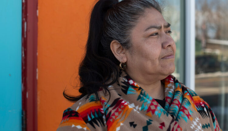 A photo of a woman posing outside.