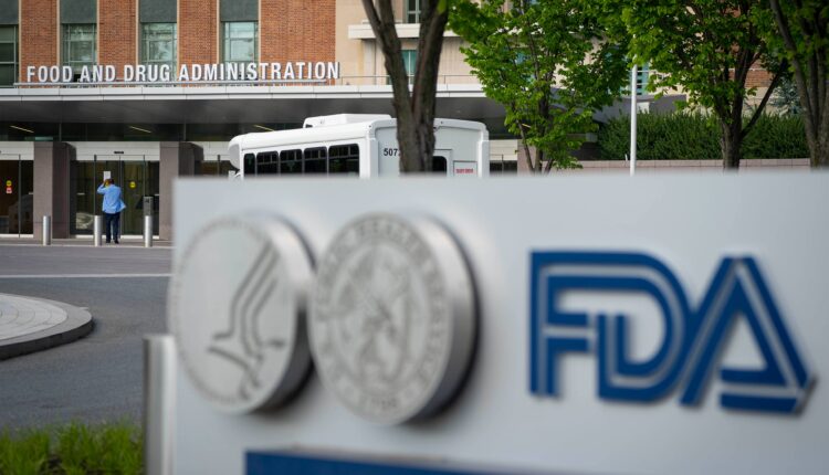 A photo of a sign with the FDA's logo in front of its headquarters.