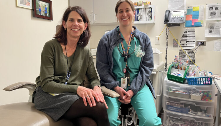 Pediatrician Patricia Braun (left) and Valerie Cuzella (right) sit side by side in a dental exam room.